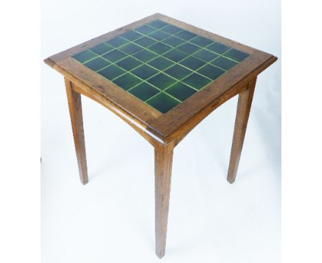 A Heals Arts and Crafts tile top oak occasional table, the square top raised on tapering square section supports, 76 x 61 x 6