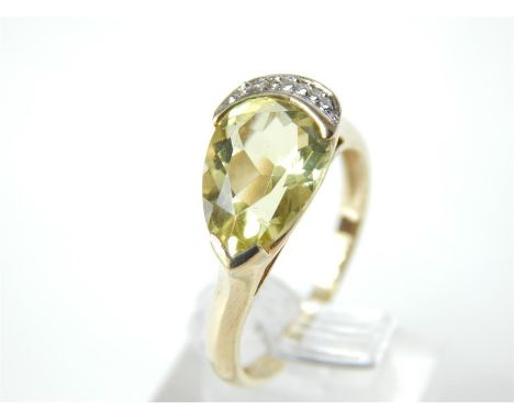 A striking, vintage, 9 ct yellow gold and citrine and diamond ring, composed of a tear-drop shaped, faceted, yellow/green cit