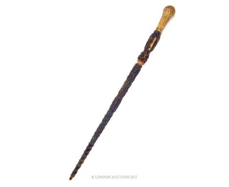 An eastern twine covered swagger stick with yellow metal knop; 60cm long.