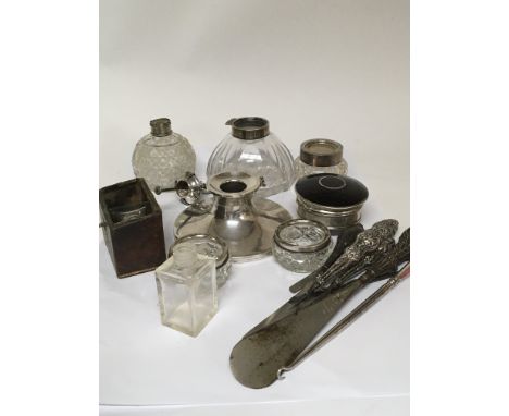 A collection of silver mounted ink wells perfume bottles and Silver handled button hooks.