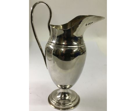 A silver helmet shaped jug, London hallmarks for Walter, John, Michael, Stanley Barnard and Robert Dubock.Approx 21cm, 379g