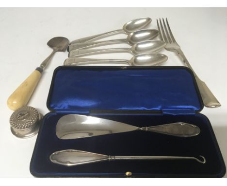 A cased silver handled button hook and shoe horn a small silver circular box, and four Silver table spoons with London 1897.