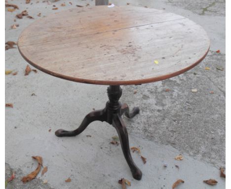 A Georgian faded mahogany circular tilt top occasional table, on turned column and tripod splay supports, 35" dia