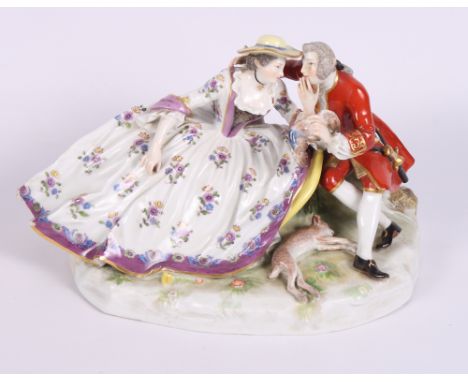 A continental porcelain group of children playing 'blind man's buff', 5" high, a continental porcelain figure, dog with baske