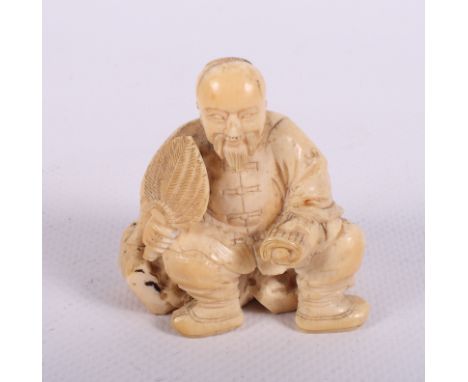 A 19th Century Japanese carved ivory okimono of a seated man holding a fan and scroll, another of a tiger attacking a hippopo