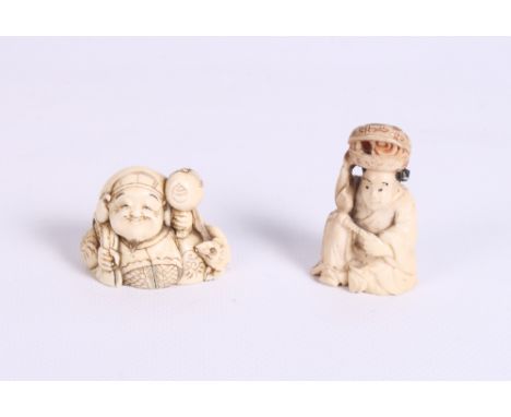 A Japanese carved ivory netsuke formed as a seated male with a rat and a small carved ivory okimono of a seated figure