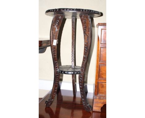 A Chinese carved hardwood circular top occasional table, on tripod supports