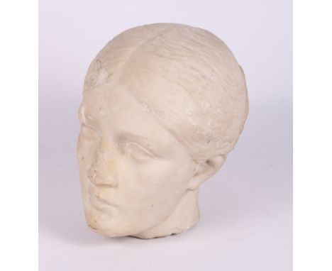 An antique carved marble portrait head of a classical woman with her hair in a bun, 9" high