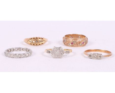 Three 18ct gold and gem set dress rings, a 9ct gold, diamond and ruby set dress ring and a white metal and diamond set eterni