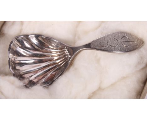 A Scottish silver scallop bowl caddy spoon by J Ritchie, retailed by Hamilton & Inches, in original box