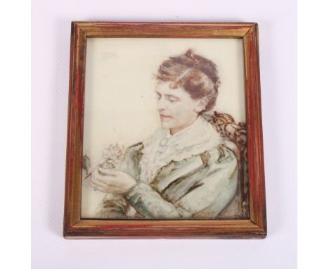 A late 19th Century portrait miniature of a woman holding a rose, 4 1/2" x 3 3/4", in gilt strip frame
