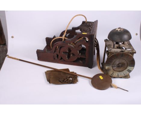An early brass bracket clock with single hand and  silvered chapter ring, striking movement, on carved walnut bracket dial in