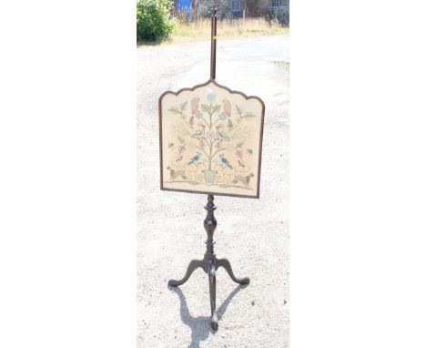 A mahogany framed firescreen with crewel work panel, on tripod supports