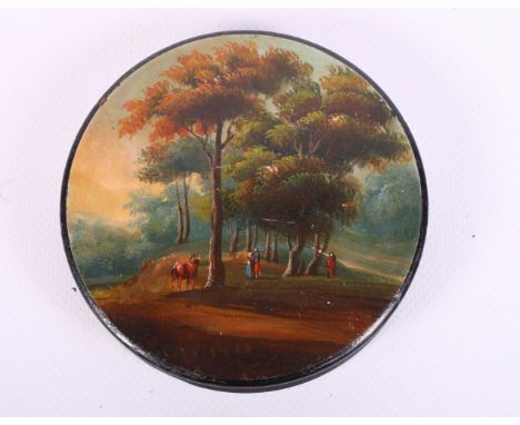 A 19th Century papier-mache snuff box with landscape decoration, 4" dia