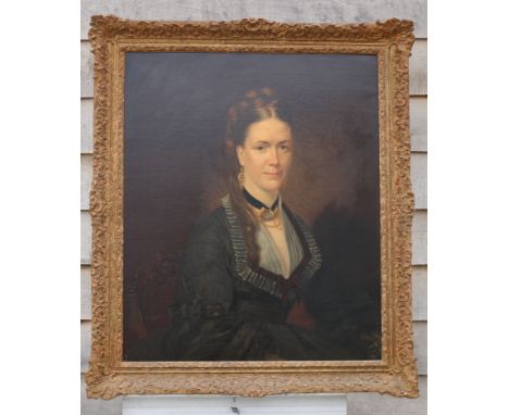 A mid 19th Century oil on canvas, portrait of an unknown woman with tiger claw pendant, 29" x 24", in gilt swept frame