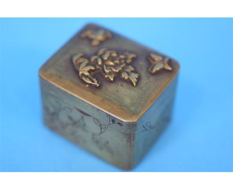 A small Japanese trinket box the lid decorated with flowers, birds and butterflies, the sides engraved with flowers.  4 cm wi