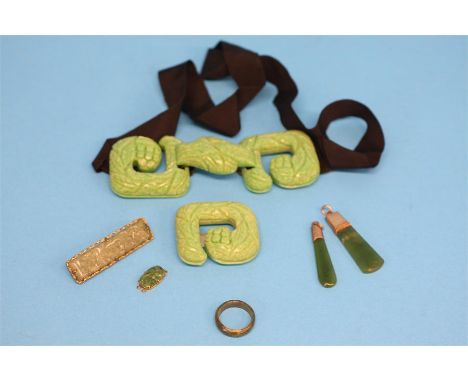 Two jade pendants, a jade ring, a bar brooch and a jade coloured buckle.