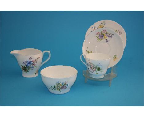 A Shelley "Wild Flowers" tea service comprising six cups, six saucers, six side plates, cake plate, cream jug and a sugar bow