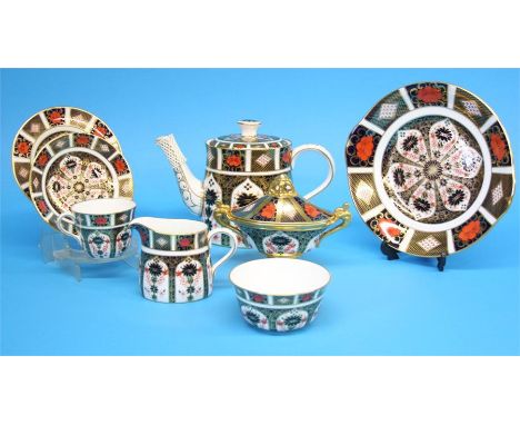 A Royal Crown Derby Imari tea service comprising teapot, cream jug, sugar bowl, seven cups, seven saucers, six side plates, o