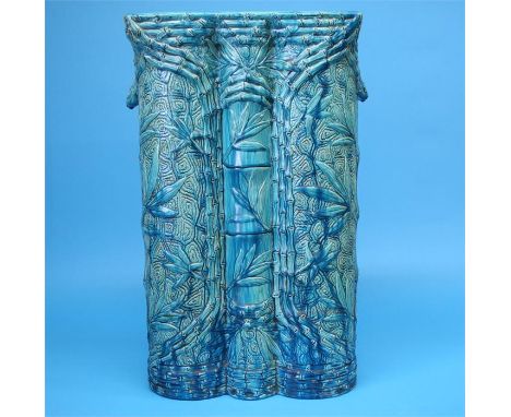 A large Burmantoft's Faience umbrella/stick stand with relief moulded decoration in the oriental manner, entwined with bamboo