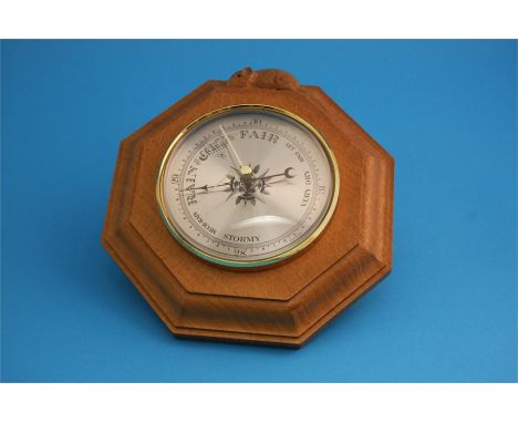 A Robert Mouseman Thompson of Kilburn octagonal barometer and a carved ashtray.