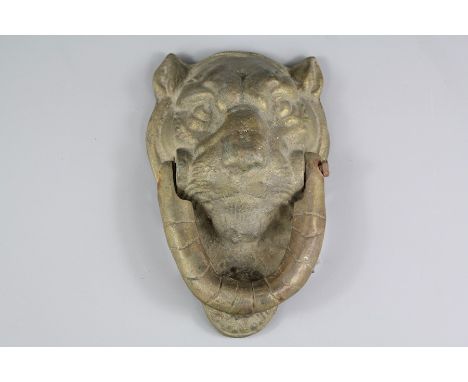 A Cast Metal Door-knocker; the knocker in the shape of a lion's head, approx 12 x 20 cms.&nbsp;