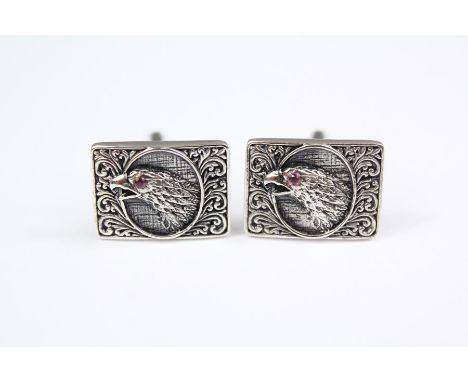 A Pair of Gentleman's Silver Cuff-links; the cuff-links depicting birds of prey with ruby eyes, approx 15.7 gms.