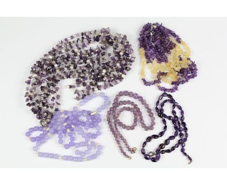 Purple Quartz Amethyst and Glass Bead Necklaces: a four-strand drop necklace, approx 40 cms, a three-strand drop necklace, ap