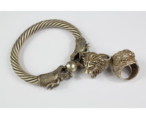Two Chinese White Metal Rings together with a bangle depicting dragons chasing a pearl of wisdom. (3)