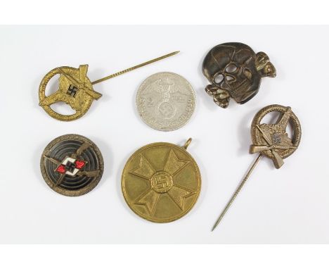 WWII Era German SS and Nazi Insignia, including a rare SS troops cap/collar badge, two brass marks men stock pins, enamel col