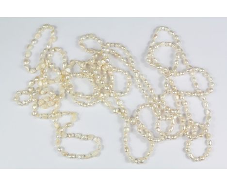 Three White Fresh Water Baroque Pearl Necklaces: pearls approx 5 - 10 mm, approx 100 cms and one approx 116 cms. (4)