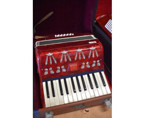A compact piano accordion, with hard case