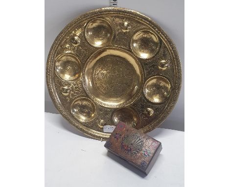 A large brass Horderves dish and a brass box with peacock motif containing wooden draughts, shipping unavailable