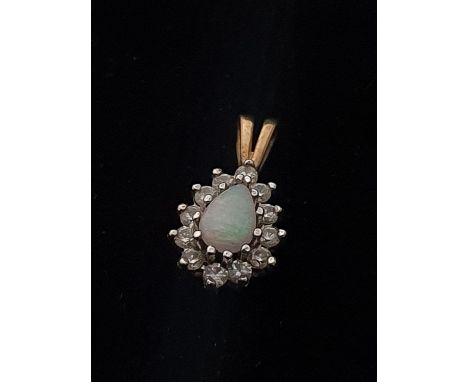 A 9ct gold opal and white stone pendant