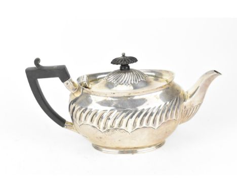 A Victorian silver teapot by Henry Stratford, Sheffield 1892, of oval form with ebonised finial and handle, 24 cm wide, weigh