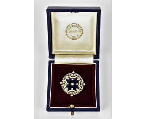 A late Victorian/early 20th century brooch, in white metal, diamond, enamel and seed pearl, in a fitted box for Tessiers, of 