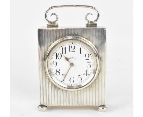 A George V silver cased 8 days travel clock, the silver by Cohen &amp; Charles, Chester 1916, with white enamel dial with Ara
