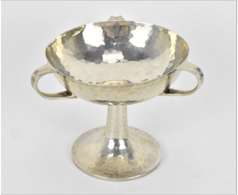 An Edwardian Art Nouveau silver hammered bowl on stand by William Hutton &amp; Sons, London 1906, with three loop handles aro
