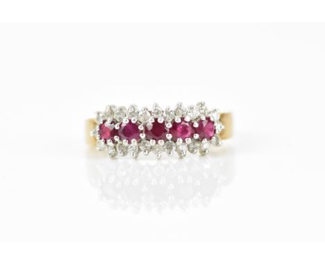 A 9ct yellow gold, white metal, diamond and ruby dress ring, designed with a row of five round cut rubies in a diamond halo, 