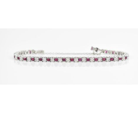 An 18ct white gold, diamond and ruby bracelet, with alternating round brilliant cut diamond and tension set princess cut ruby