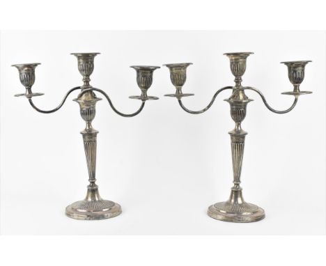 A pair of late Victorian silver convertible candelabra by Fordham &amp; Faulkner, Sheffield 1898, in the Adam style with flut