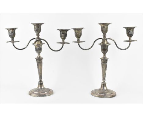 A pair of late Victorian silver convertible candelabra by Fordham &amp; Faulkner, Sheffield 1898, in the Adam style with flut