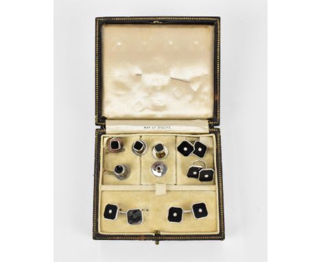 A set of Art Deco black 9ct white gold, black enamel and seed pearl cufflinks, buttons and shirt studs, comprising one pair o