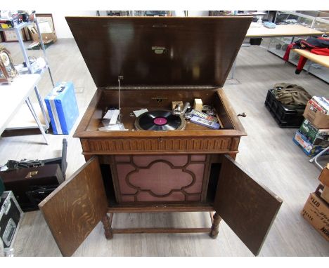 A Columbia oak cased cabinet gramophone with twin panelled doors housing speaker (water damage to cabinet)