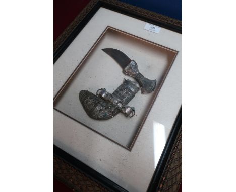 Framed and mounted small jambiya dagger with white metal overlay detail in fitted display case 