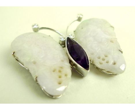 A mutton fat jade brooch, formed as a butterfly, set with diamond eyes and feelers and marquise amethyst body, the wings carv
