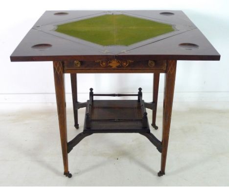 A mid Victorian rosewood, line and marquetry inlaid envelope card table, fold out quarter leaves with dished gaming chip holl