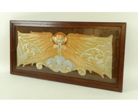 An Art Nouveau embroidery, depicting an angel in gold and silk thread, 54 by 21cm, framed.