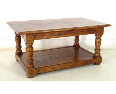 A modern pollard oak coffee table, rectangular three plank surface with moulded edge, turned baluster supports, lower three p