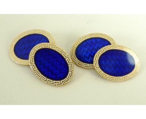 A pair of 18ct gold chain link oval cuff-links, with central blue enamel within a cream coloured border decorated with Greek 